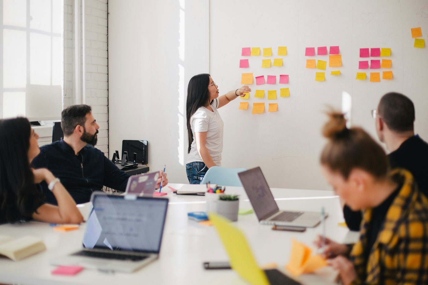 A team reviewing notes together in a meeting room.
